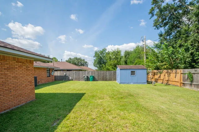 a view of a house with a yard and sitting area