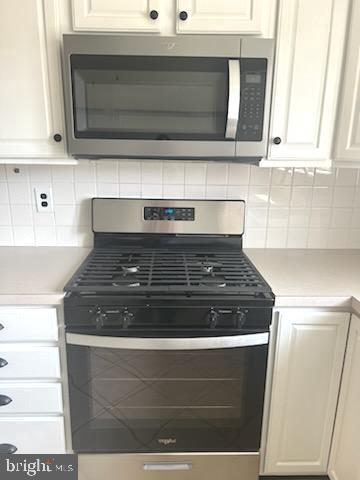 328 Hoffnagle Street, Unit 2 Philadelphia, PA 19111 - Photo 13 of 39 a stove top oven sitting inside of a kitchen
