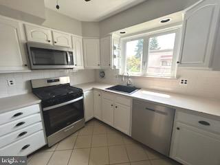 328 Hoffnagle Street, Unit 2 Philadelphia, PA 19111 - Photo 14 of 39 a kitchen with a sink stove and microwave