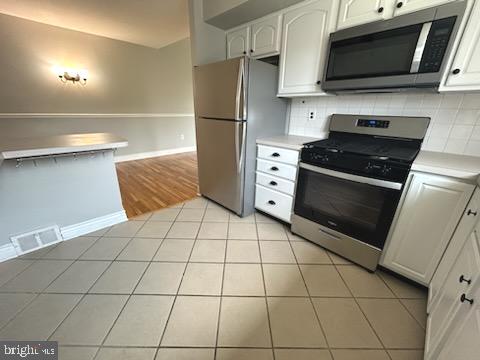 328 Hoffnagle Street, Unit 2 Philadelphia, PA 19111 - Photo 15 of 39 a kitchen with stainless steel appliances a stove a microwave and a refrigerator