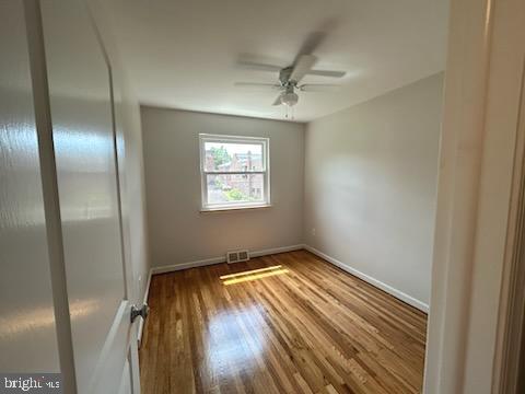 328 Hoffnagle Street, Unit 2 Philadelphia, PA 19111 - Photo 26 of 39 a view of an empty room with wooden floor and a window