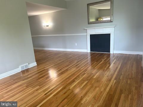 328 Hoffnagle Street, Unit 2 Philadelphia, PA 19111 - Photo 5 of 39 a view of empty room with wooden floor and fireplace