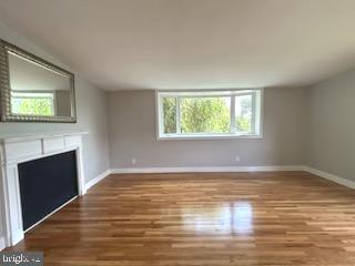 328 Hoffnagle Street, Unit 2 Philadelphia, PA 19111 - Photo 6 of 39 a view of an empty room with wooden floor and a window