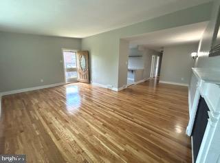 328 Hoffnagle Street, Unit 2 Philadelphia, PA 19111 - Photo 7 of 39 a view of an empty room with wooden floor and a fireplace