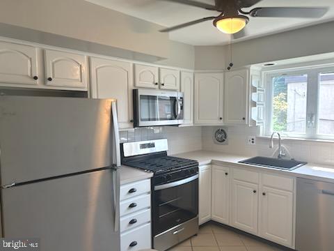 328 Hoffnagle Street, Unit 2 Philadelphia, PA 19111 - Photo 9 of 39 a kitchen with cabinets appliances a sink and a window