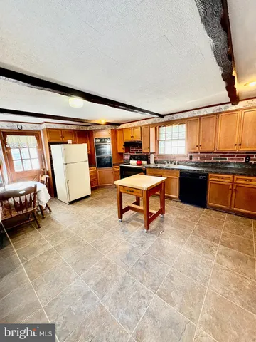 a room with a large window and furniture