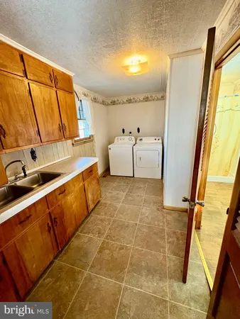 a bathroom with a tub sink and mirror