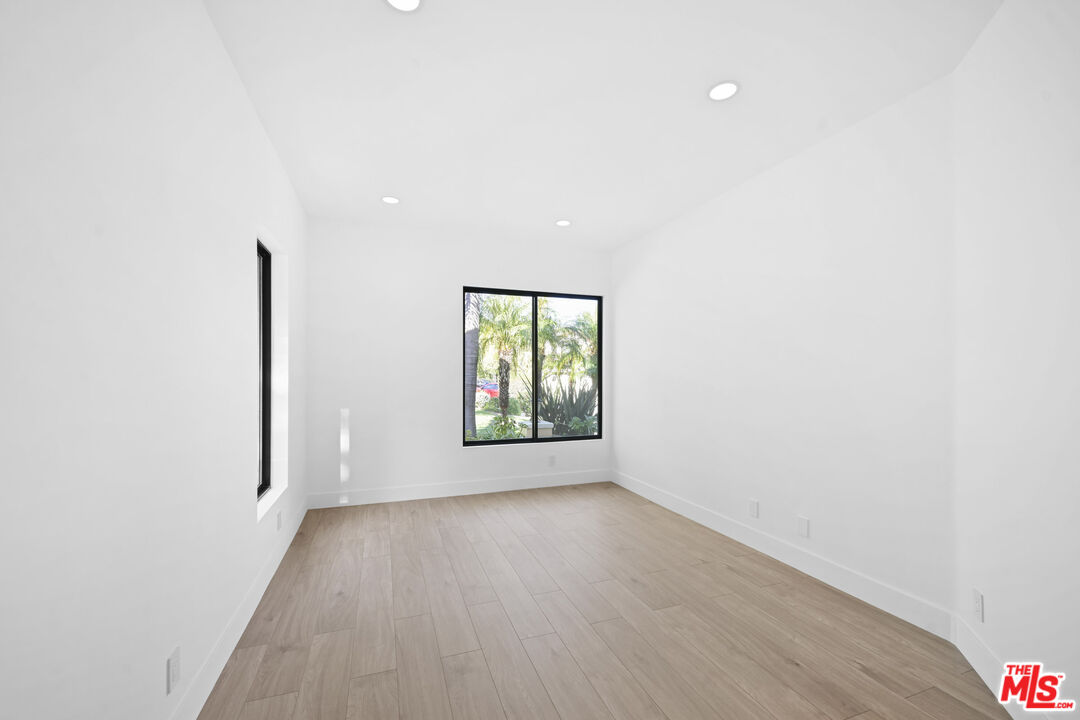 5566 Spring Hill Court Westlake Village, CA 91362 - Photo 14 of 66 a view of an empty room with wooden floor and a window