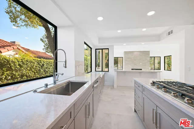 a view of a kitchen with a sink and an oven