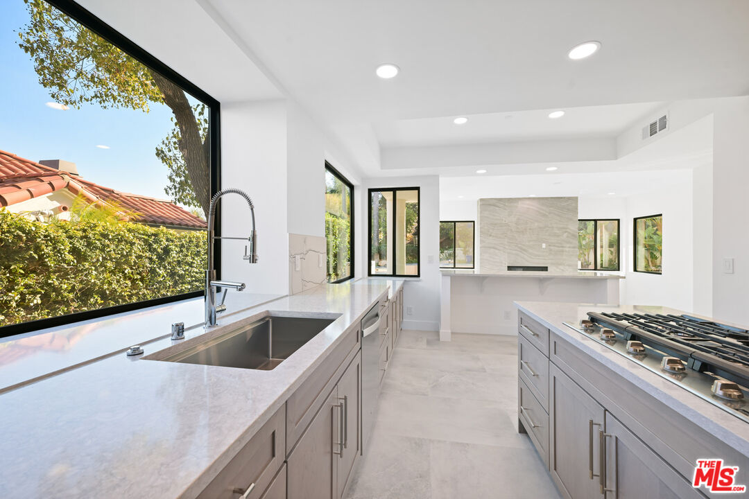 5566 Spring Hill Court Westlake Village, CA 91362 - Photo 20 of 66 a kitchen with stainless steel appliances granite countertop a sink and a stove
