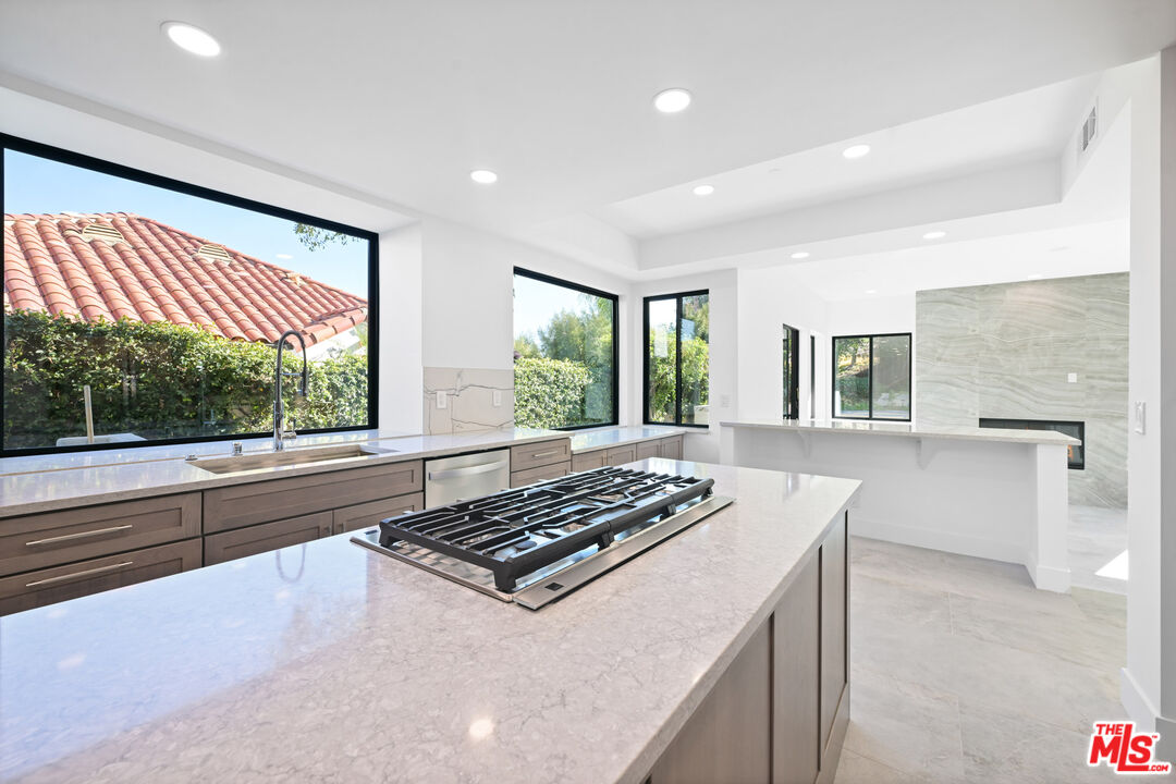 5566 Spring Hill Court Westlake Village, CA 91362 - Photo 21 of 66 a kitchen with stainless steel appliances a stove a sink and a counter top space