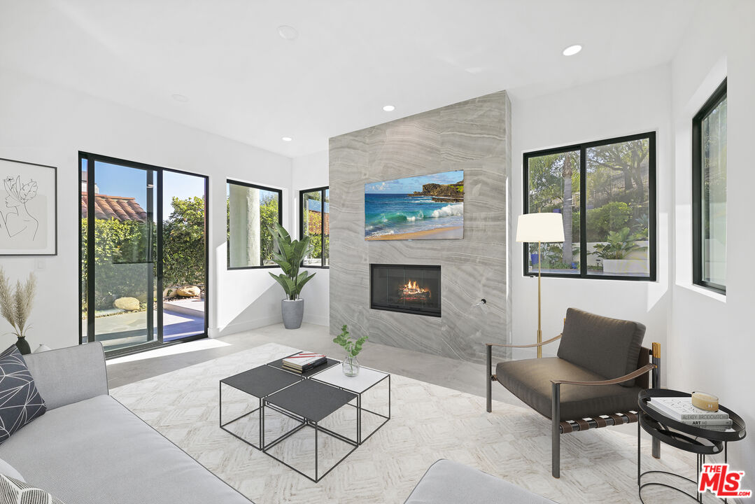 5566 Spring Hill Court Westlake Village, CA 91362 - Photo 23 of 66 a living room with furniture a fireplace and a large window