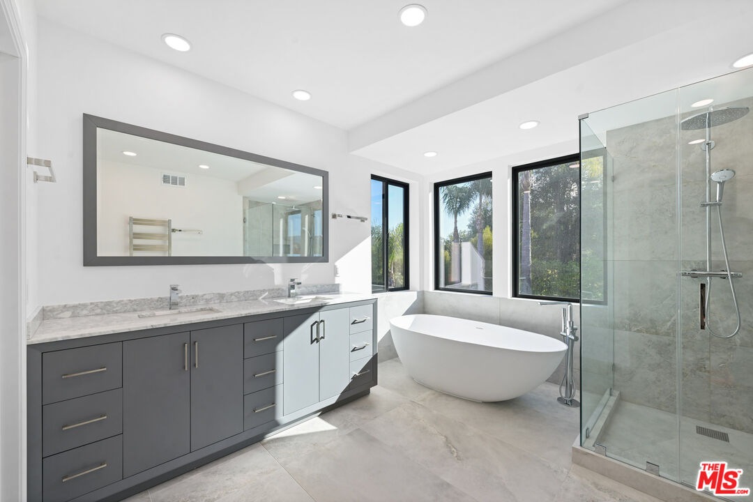 5566 Spring Hill Court Westlake Village, CA 91362 - Photo 29 of 66 a bathroom with a double vanity sink mirror and bathtub