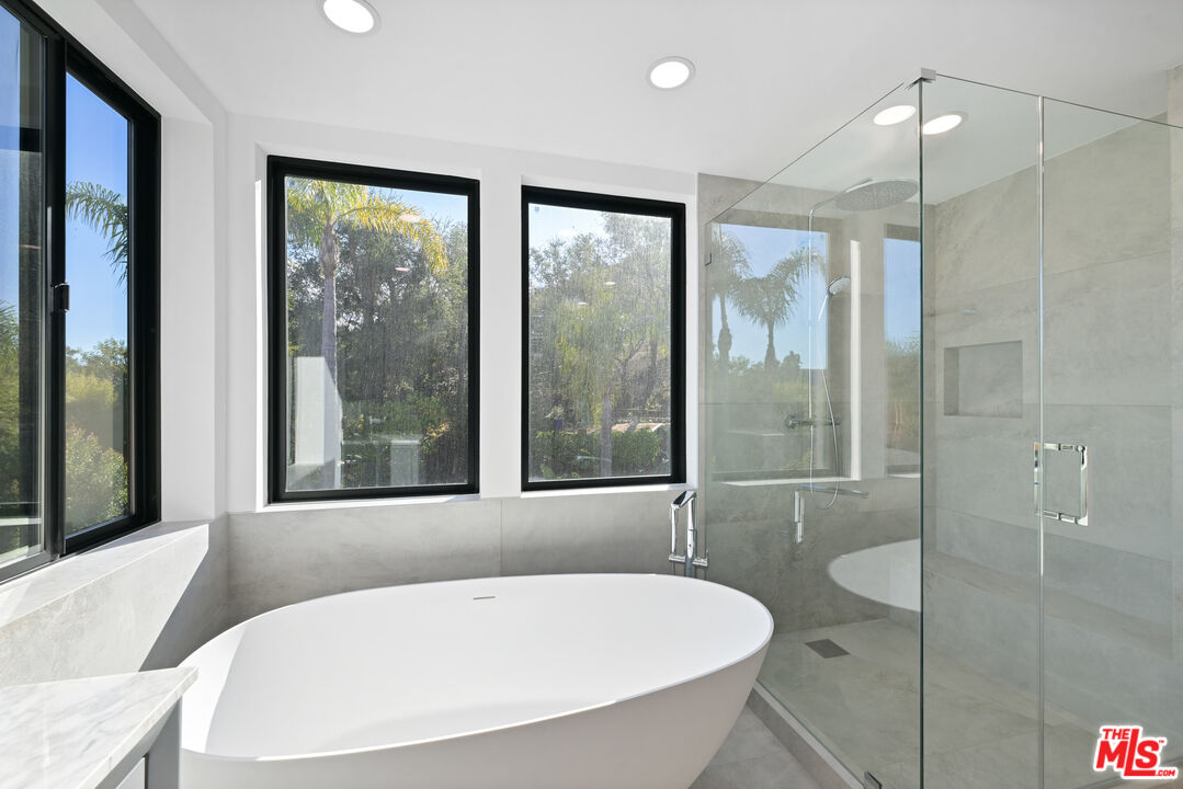 5566 Spring Hill Court Westlake Village, CA 91362 - Photo 30 of 66 a bathroom with a tub and a shower
