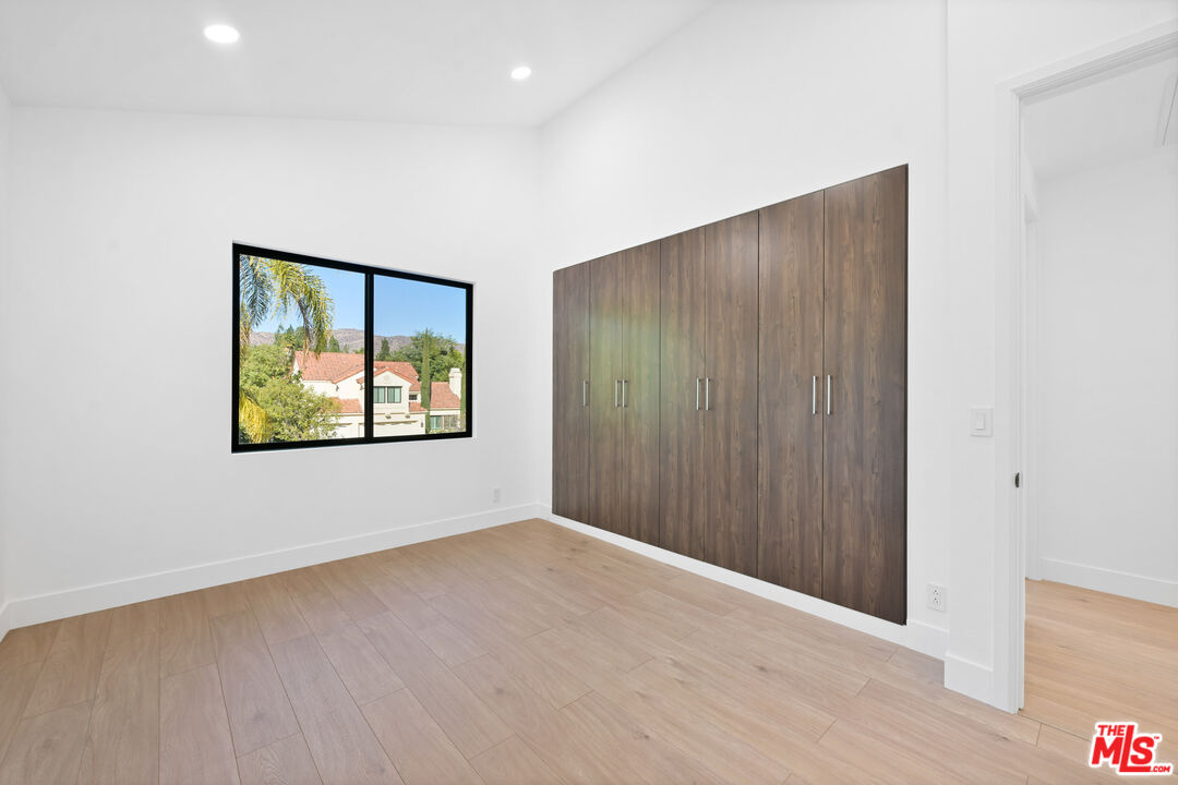 5566 Spring Hill Court Westlake Village, CA 91362 - Photo 34 of 66 a view of an empty room with wooden floor and window