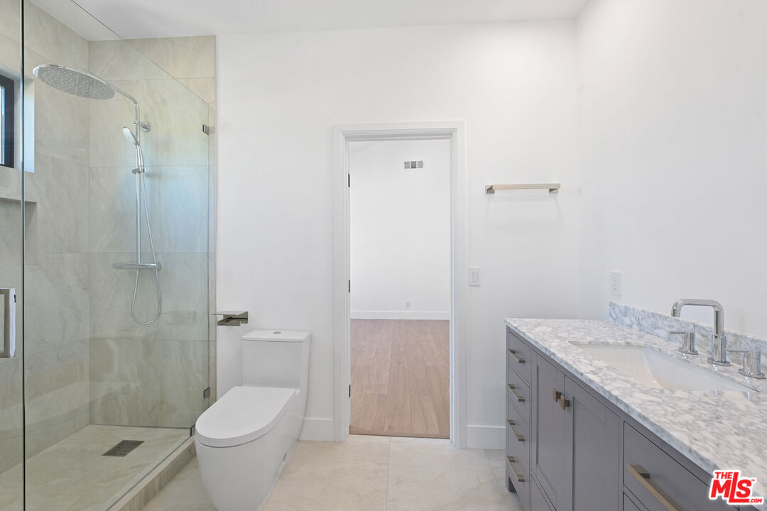 5566 Spring Hill Court Westlake Village, CA 91362 - Photo 39 of 66 a bathroom with a granite countertop sink toilet and shower