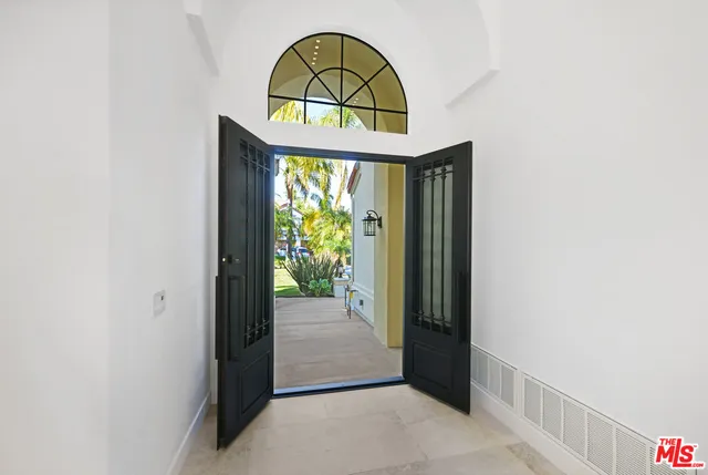 an empty room with windows and fireplace