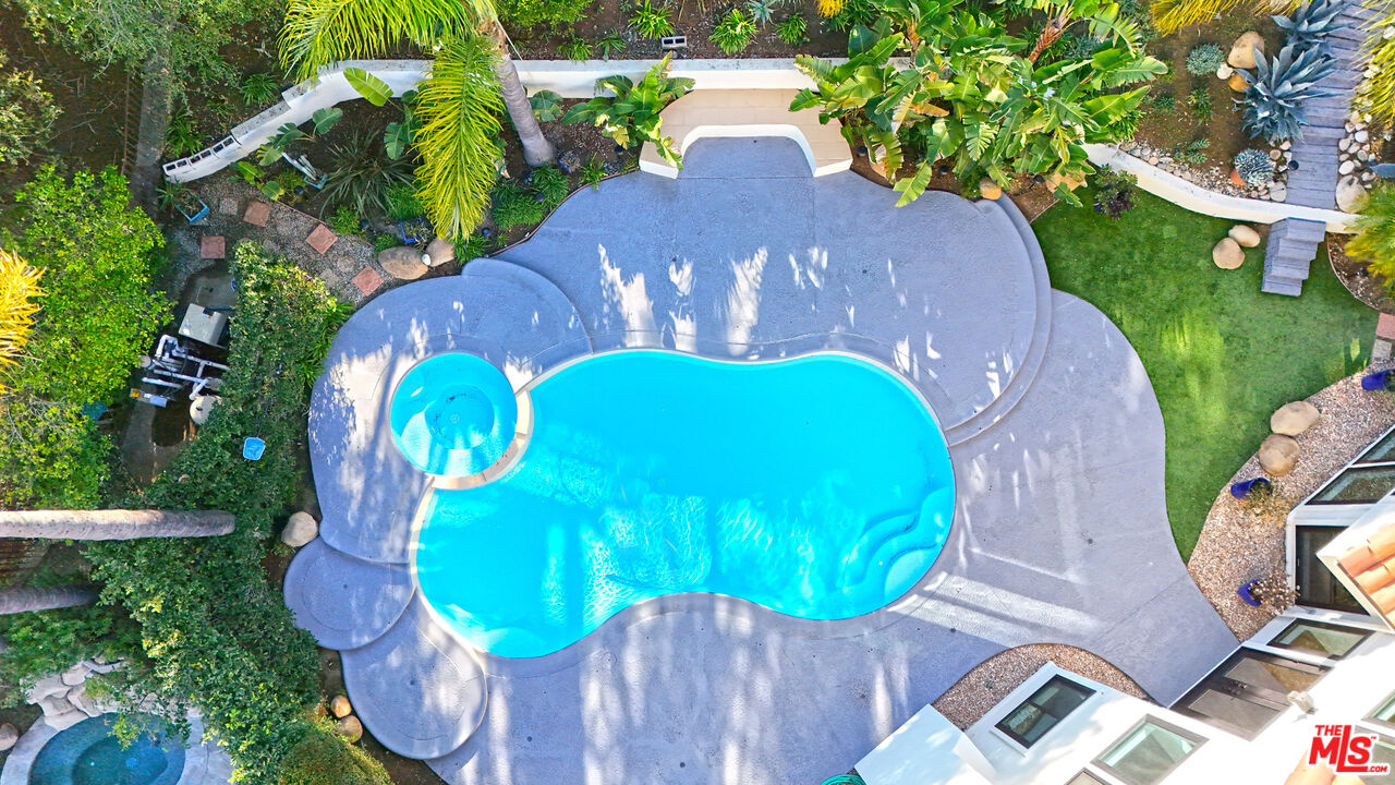 5566 Spring Hill Court Westlake Village, CA 91362 - Photo 65 of 66 a view of a swimming pool in he middle of the green field