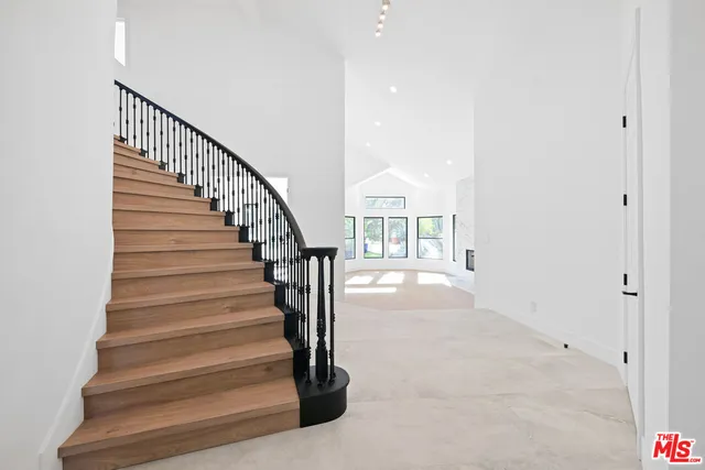 a view of a dining room with furniture a rug and wooden floor