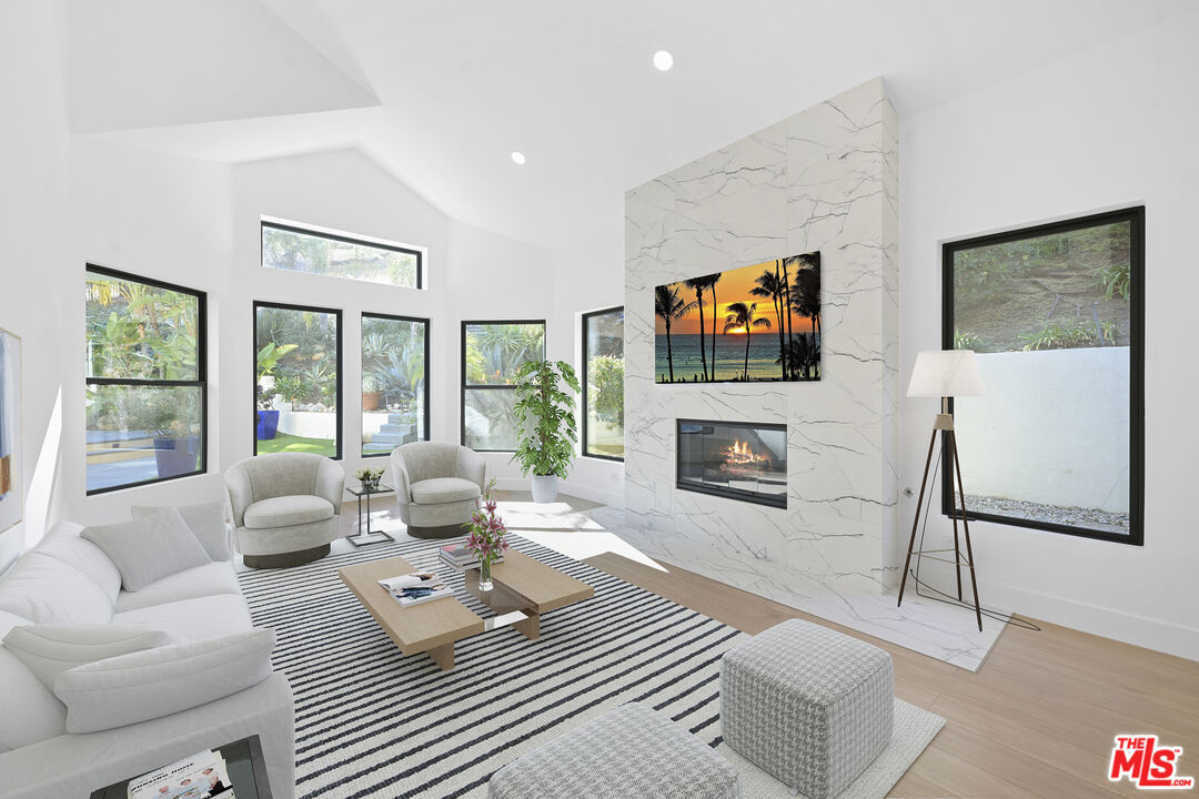 5566 Spring Hill Court Westlake Village, CA 91362 - Photo 9 of 66 a living room with fireplace furniture and a flat screen tv