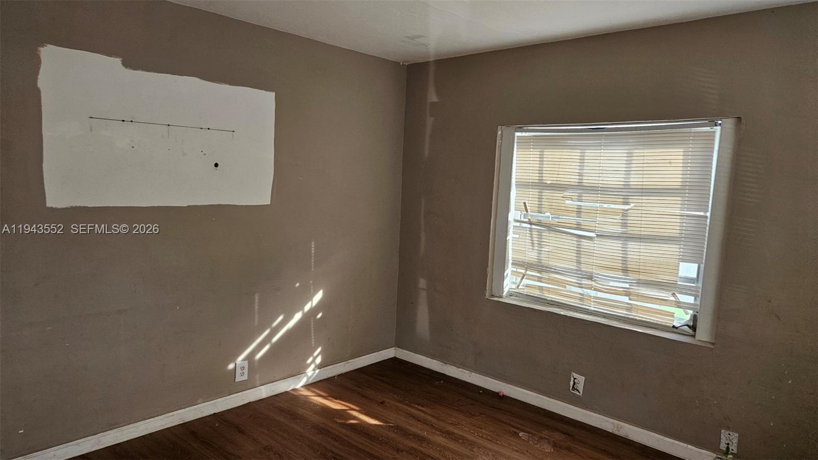 742 Southwest 10th Street Miami, FL 33130 - Photo 3 of 9 a room with wooden floor and windows
