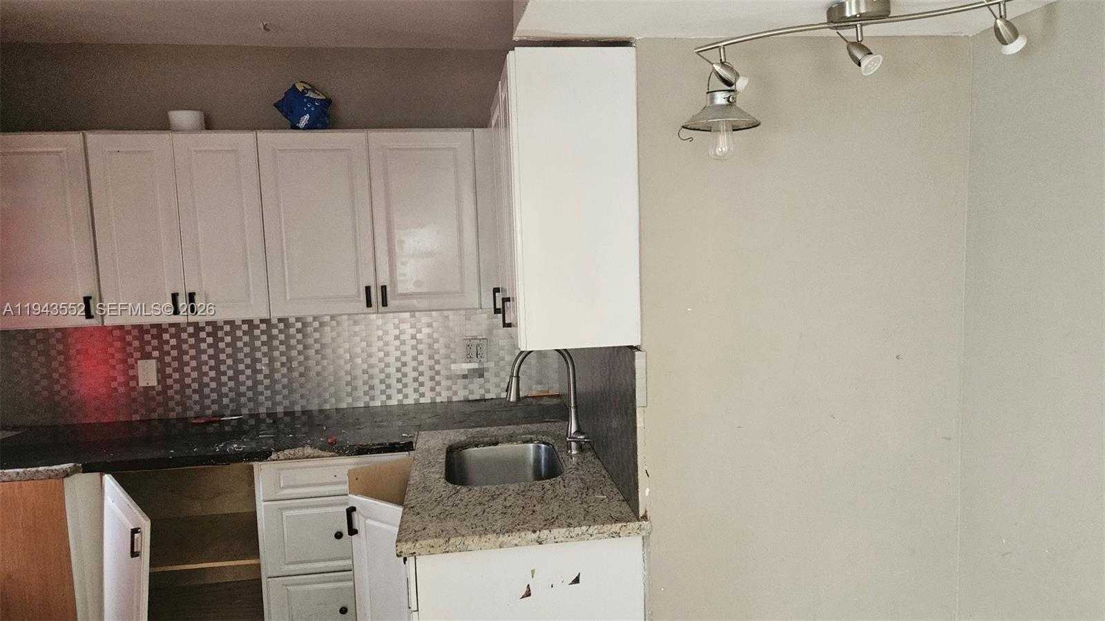 742 Southwest 10th Street Miami, FL 33130 - Photo 4 of 9 a kitchen with a sink and cabinets