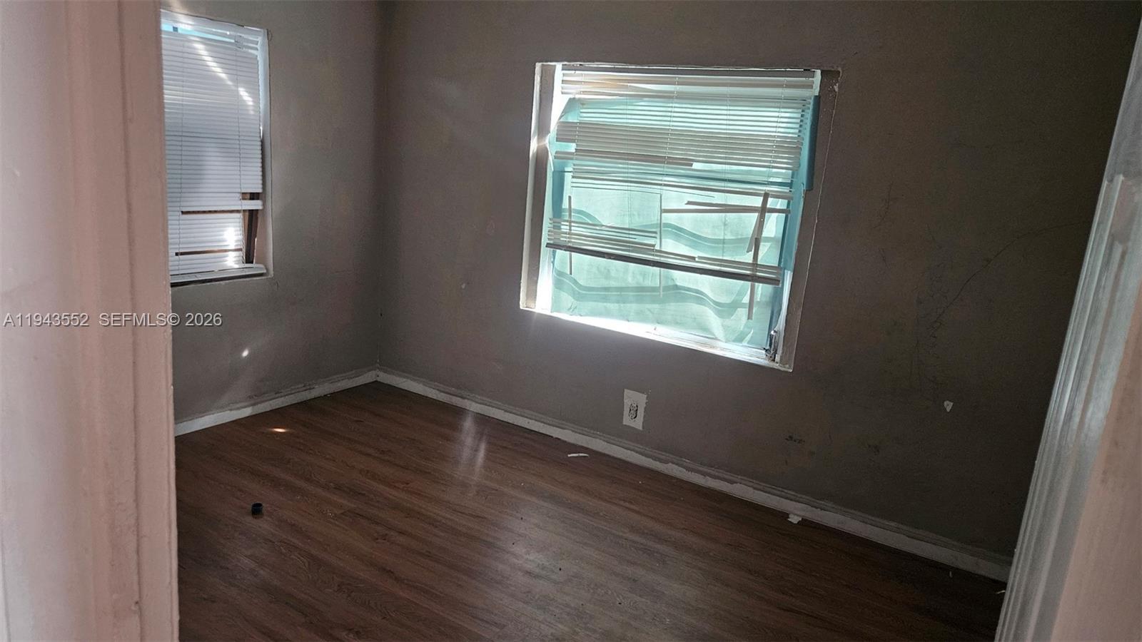 742 Southwest 10th Street Miami, FL 33130 - Photo 6 of 9 a view of an empty room with wooden floor and a window