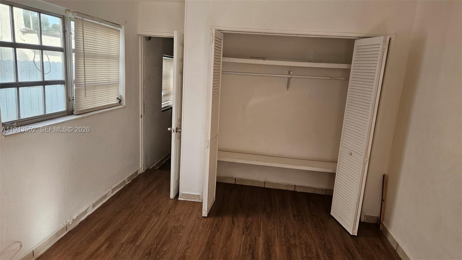 742 Southwest 10th Street Miami, FL 33130 - Photo 8 of 9 a view of walk in closet with wooden floor
