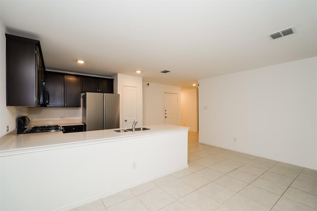 14841 Firerock Road Haslet, TX 76052 - Photo 8 of 18 a view of a kitchen with a sink and a refrigerator