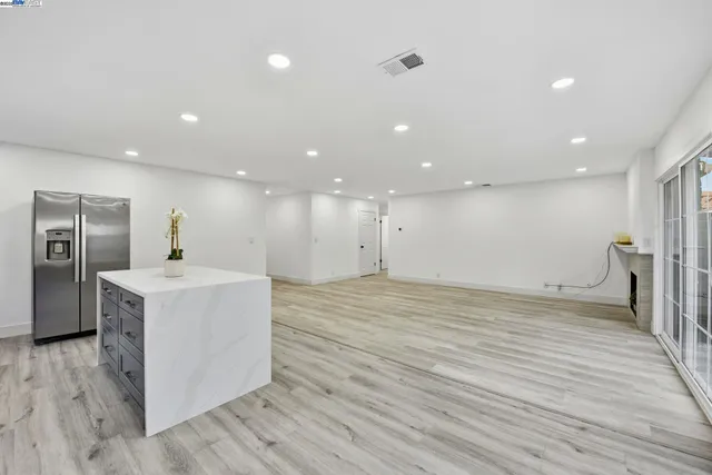 a view of a kitchen with a sink and wooden floor