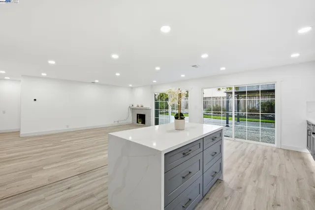 a large kitchen with kitchen island a large island in the center
