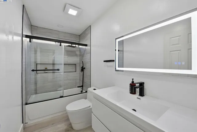 a bathroom with a sink toilet and shower