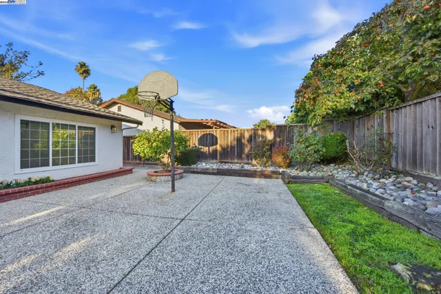 a house view with a sitting space fire pit and outdoor space