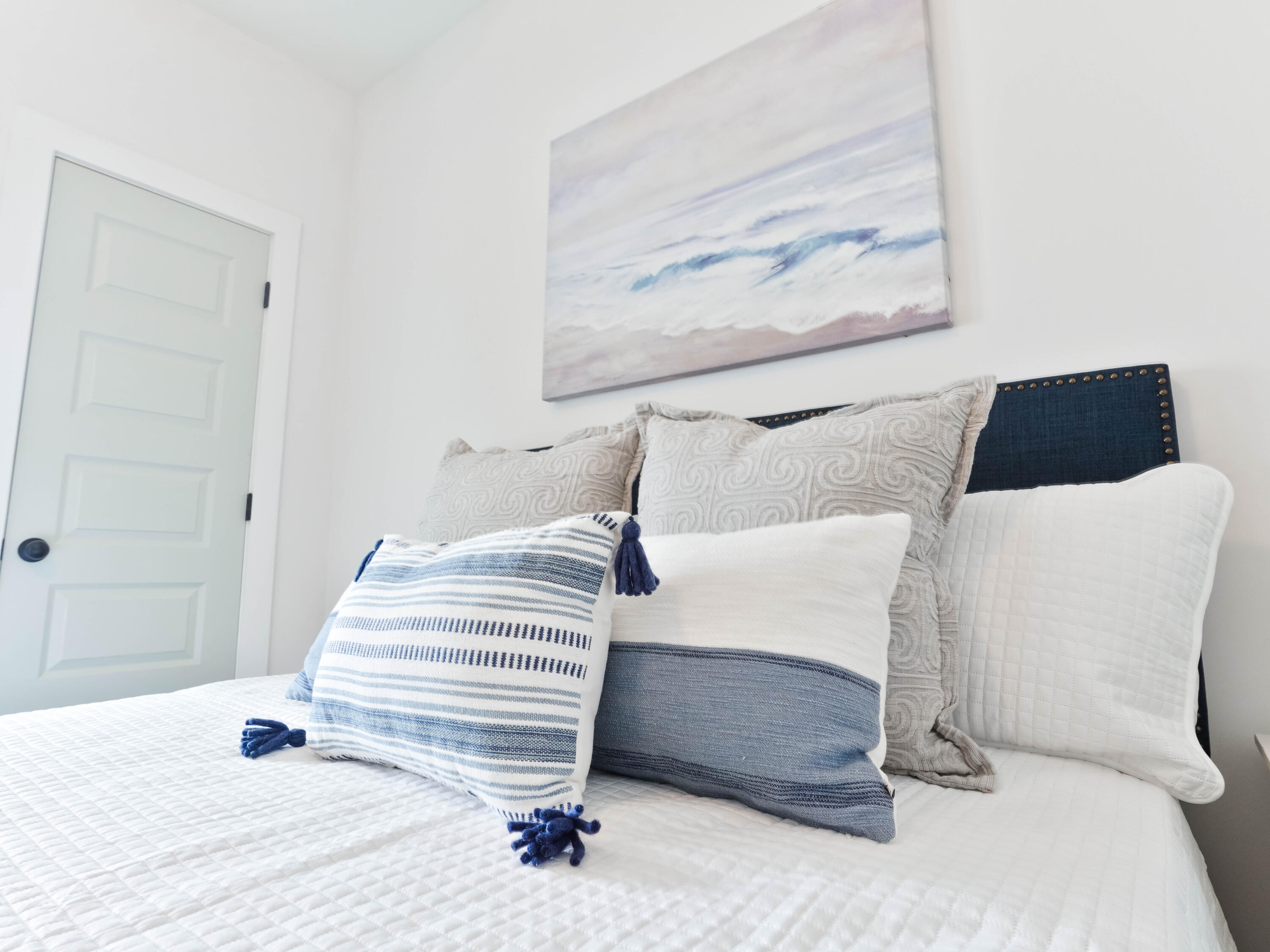 112 North Wall St Inlet Beach Inlet Beach, FL 32461 - Photo 19 of 26 a bedroom with a bed and a painting on the wall