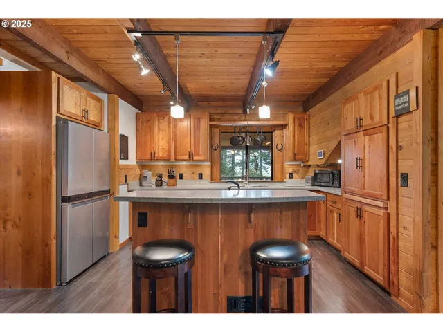 a kitchen with stainless steel appliances a refrigerator and a sink