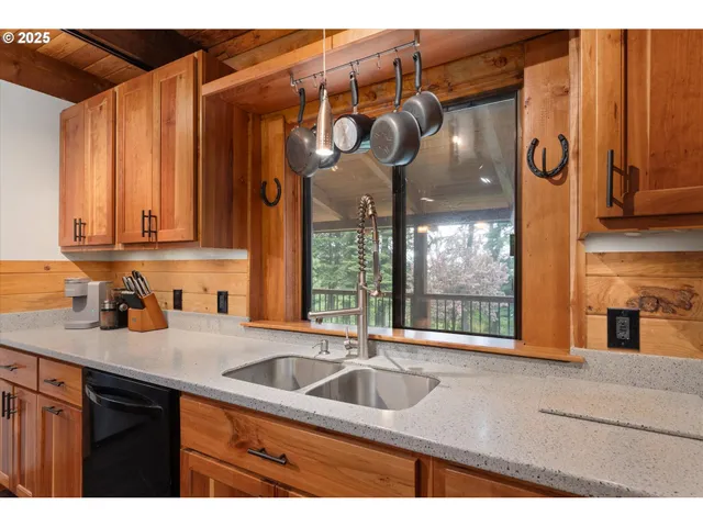 a kitchen with stainless steel appliances granite countertop a sink a stove and cabinets