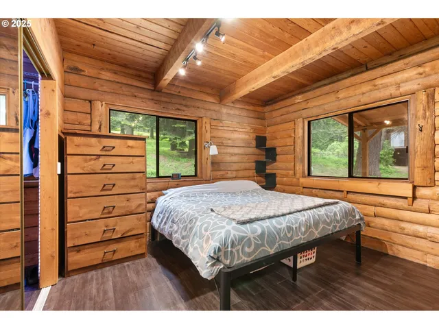 a bed sitting in a bedroom next to a window