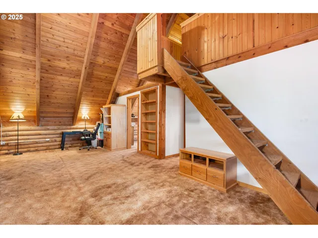a view of a livingroom with furniture and a window