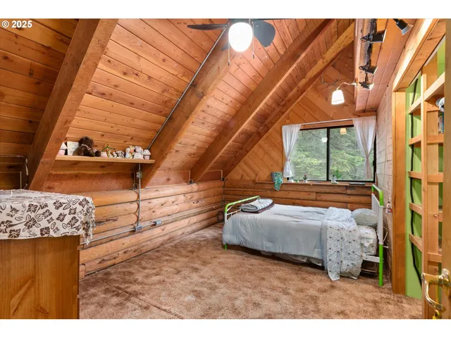 a bedroom with furniture and a large window