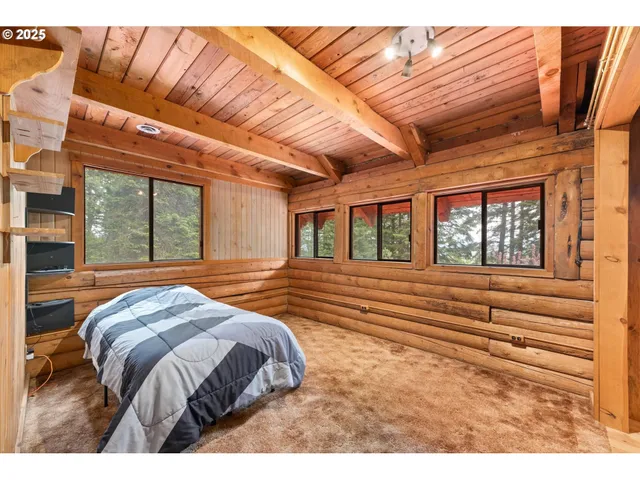 a bed sitting in a bedroom next to a window