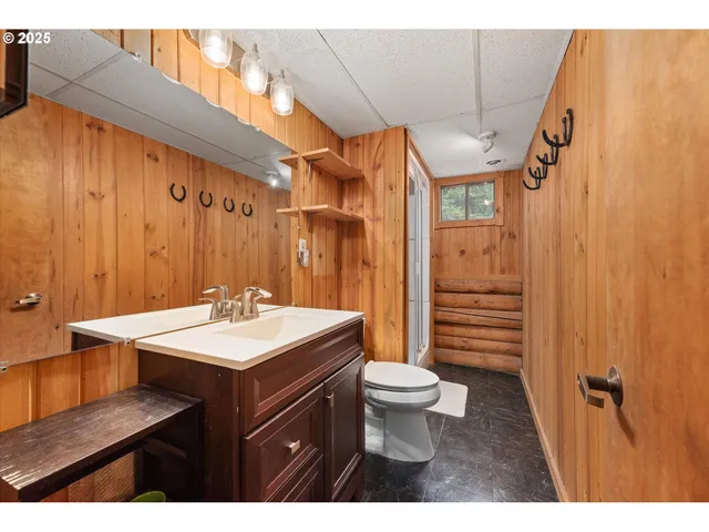 a bathroom with a sink a toilet a mirror and shower