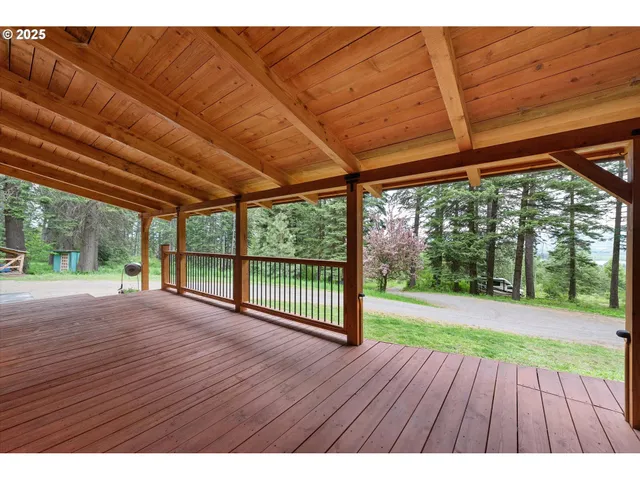 a view of a backyard with wooden floor and roof