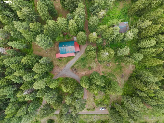 an aerial view of a house with a yard