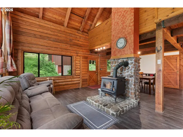 a living room with furniture and a floor to ceiling window