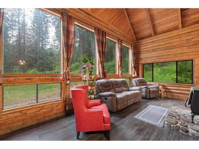 a bedroom with furniture and a large window