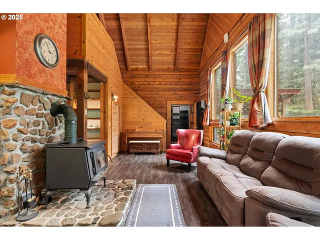 a living room with furniture a table and a large window
