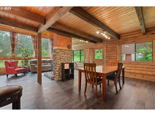 a dining room with furniture window and wooden floor