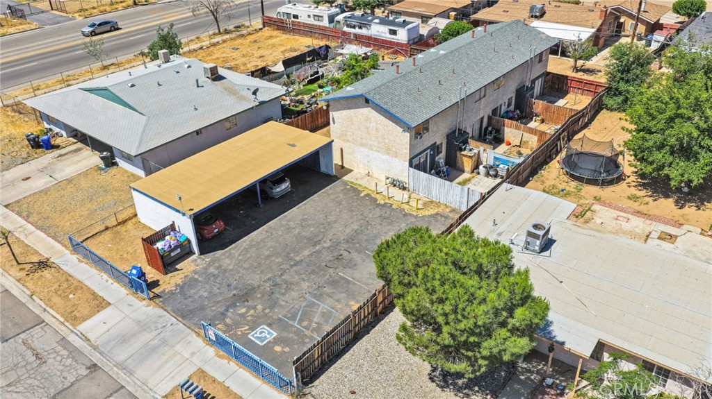 18130 Casaba Road Adelanto, CA 92301 - Photo 5 of 13 an aerial view of a house with a yard and trees