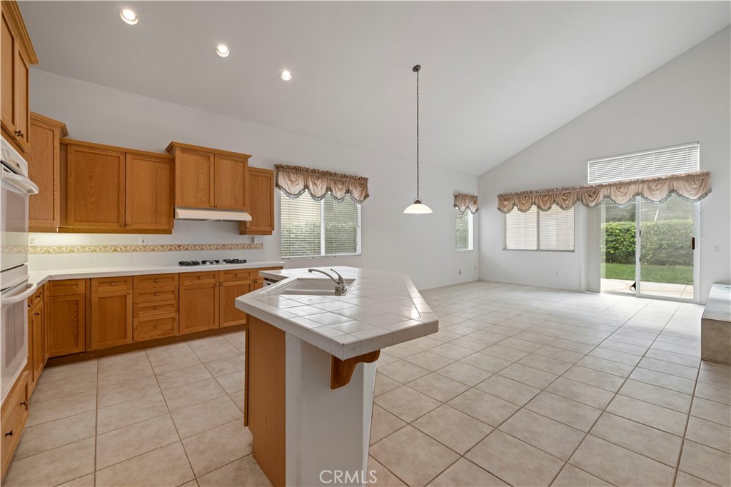 25018 Smokewood Way Stevenson Ranch, CA 91381 - Photo 35 of 71 a kitchen with a sink a counter top space appliances and cabinets
