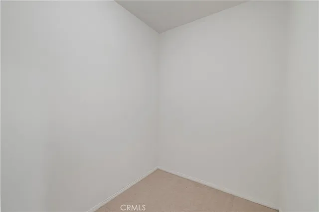 a front view of a house with a yard and potted plants